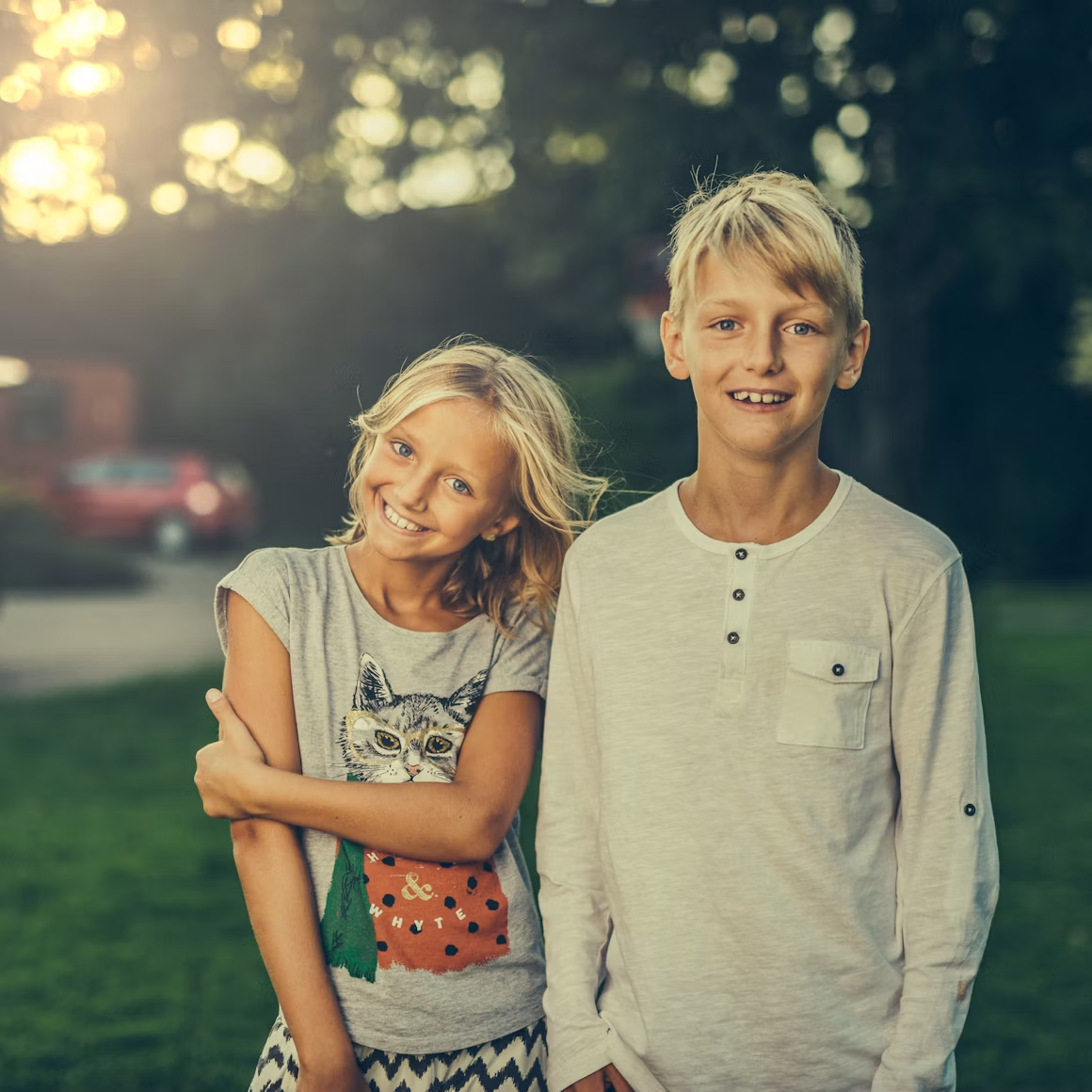 Two young teenagers smiling outdoors